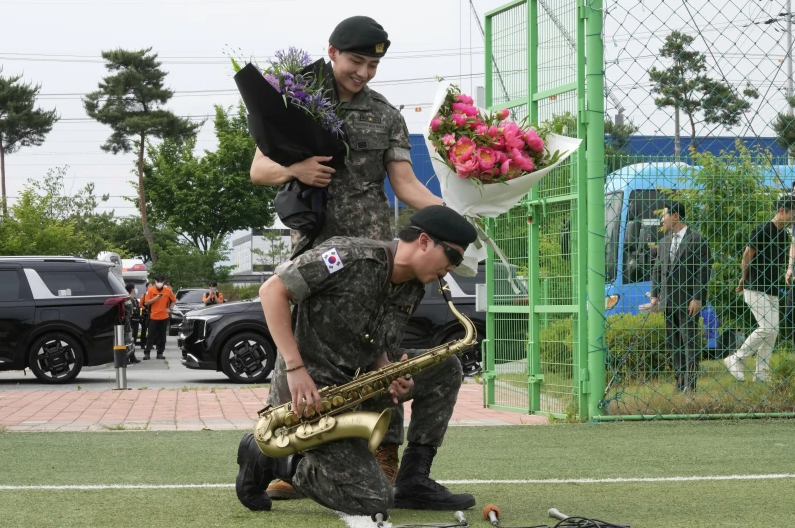 K-pop band BTS members RM, bottom, and V react after being discharged from a mandatory military service in Chuncheon, South Korea, Tuesday, June 10, 2025. (AP Photo/Ahn Young-joon)